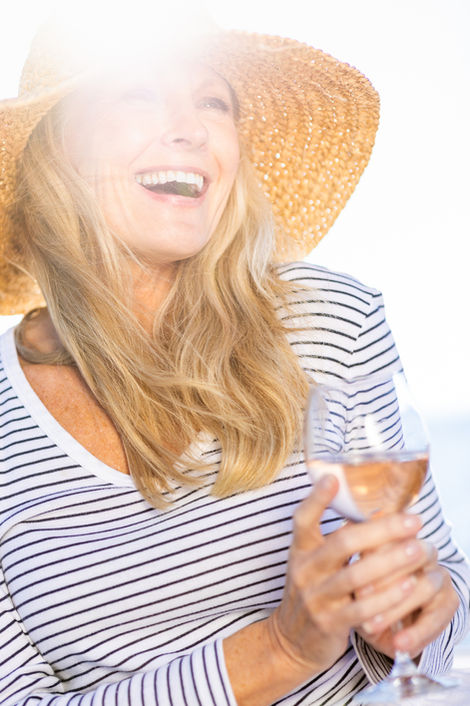 Virginia lifestyle photographer: A woman enjoying sparkling wine on the boat at Occano Resort in Merry Hill, NC.