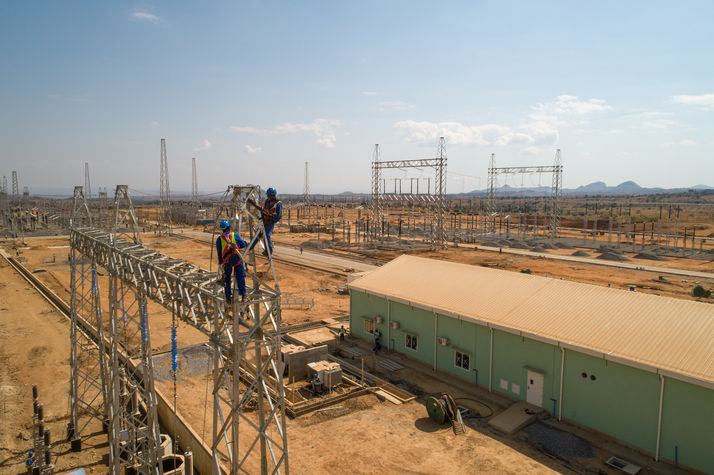 Humanitarian photographer: Drone photography of men working on the power grid in Malawi.