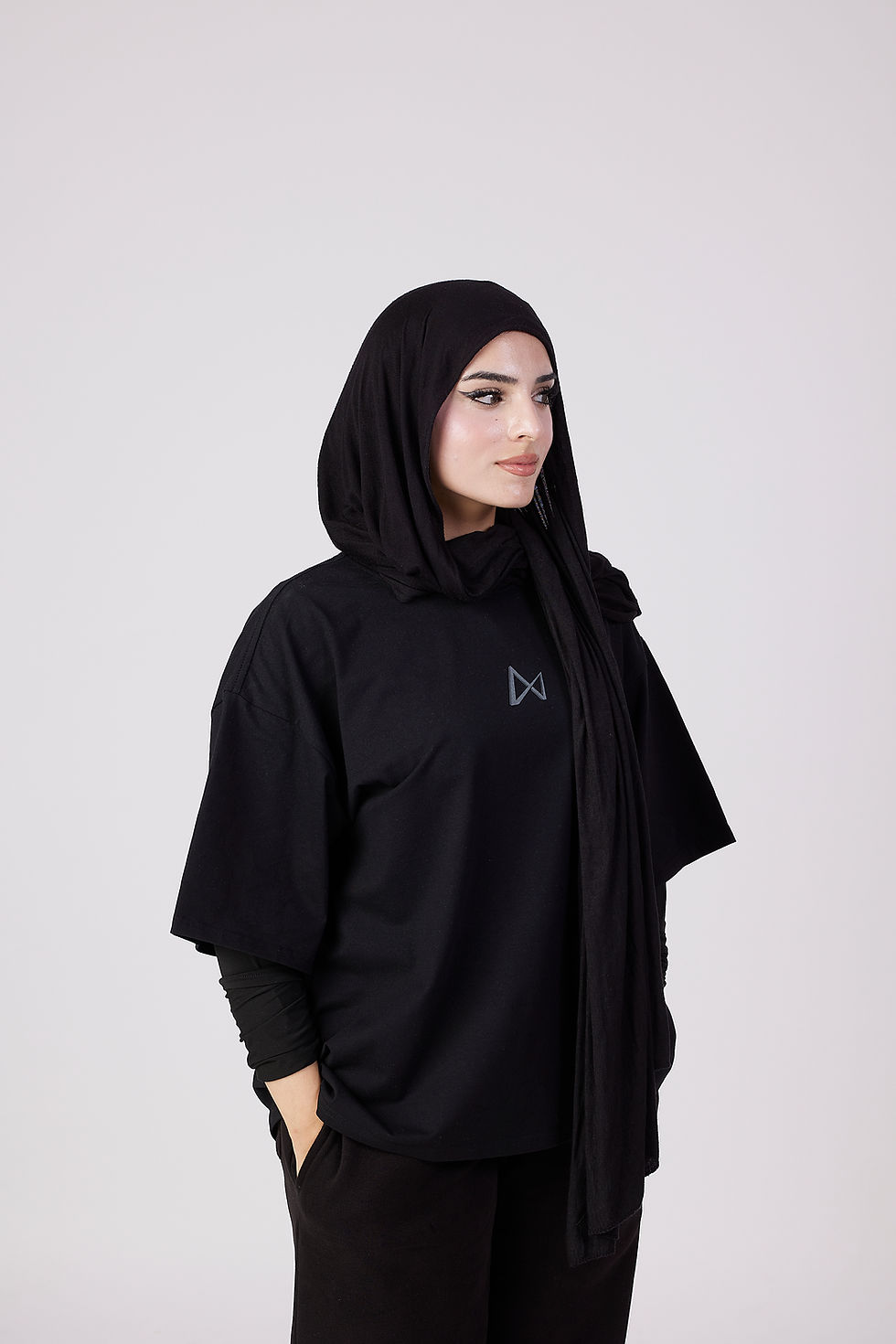 Woman wearing the Dark Matter Oversized Tee and black hijab.