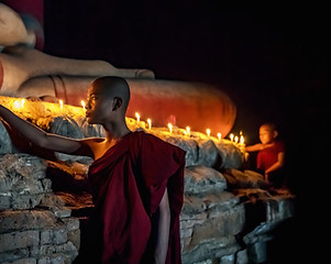 Buddhist Monk Lighting Candles