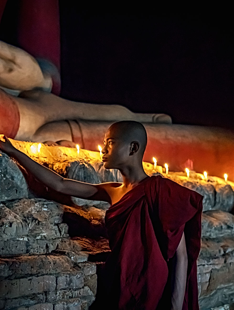 Buddhist Monk Lighting Candles