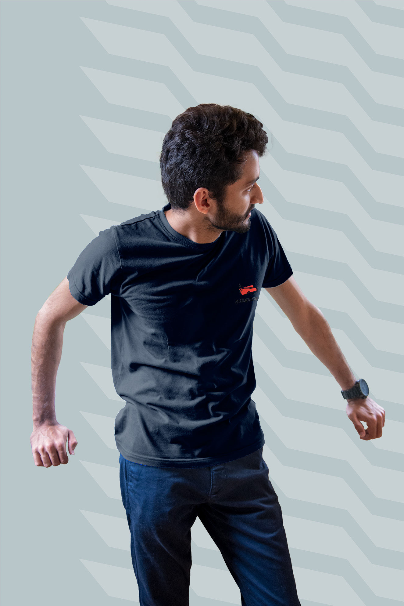 Person wearing a dark blue plain shirt with a small orange logo on the front