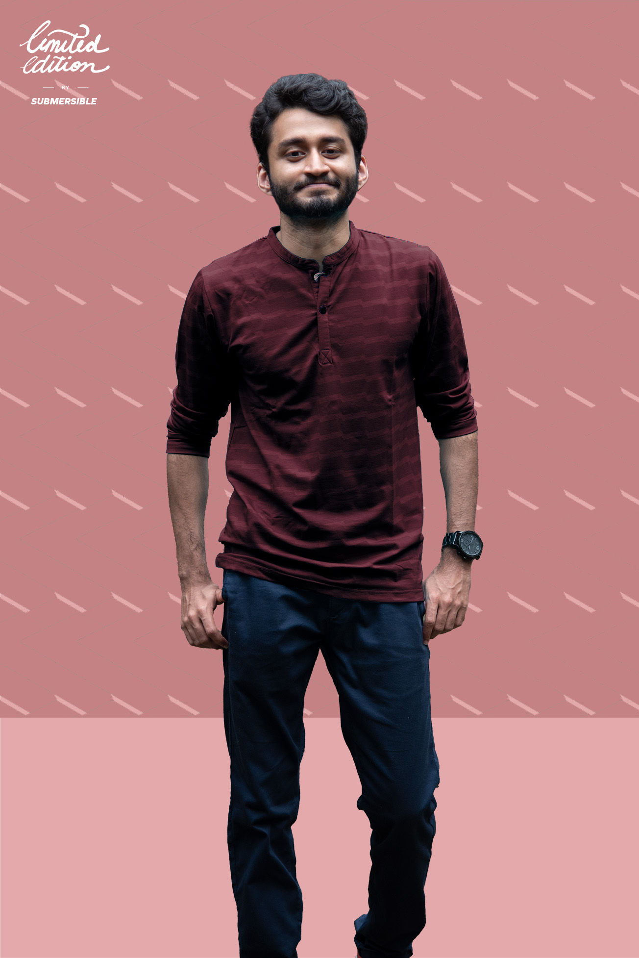 Person looking at the camera, wearing a henley neck t-shirt with rolled up sleeves