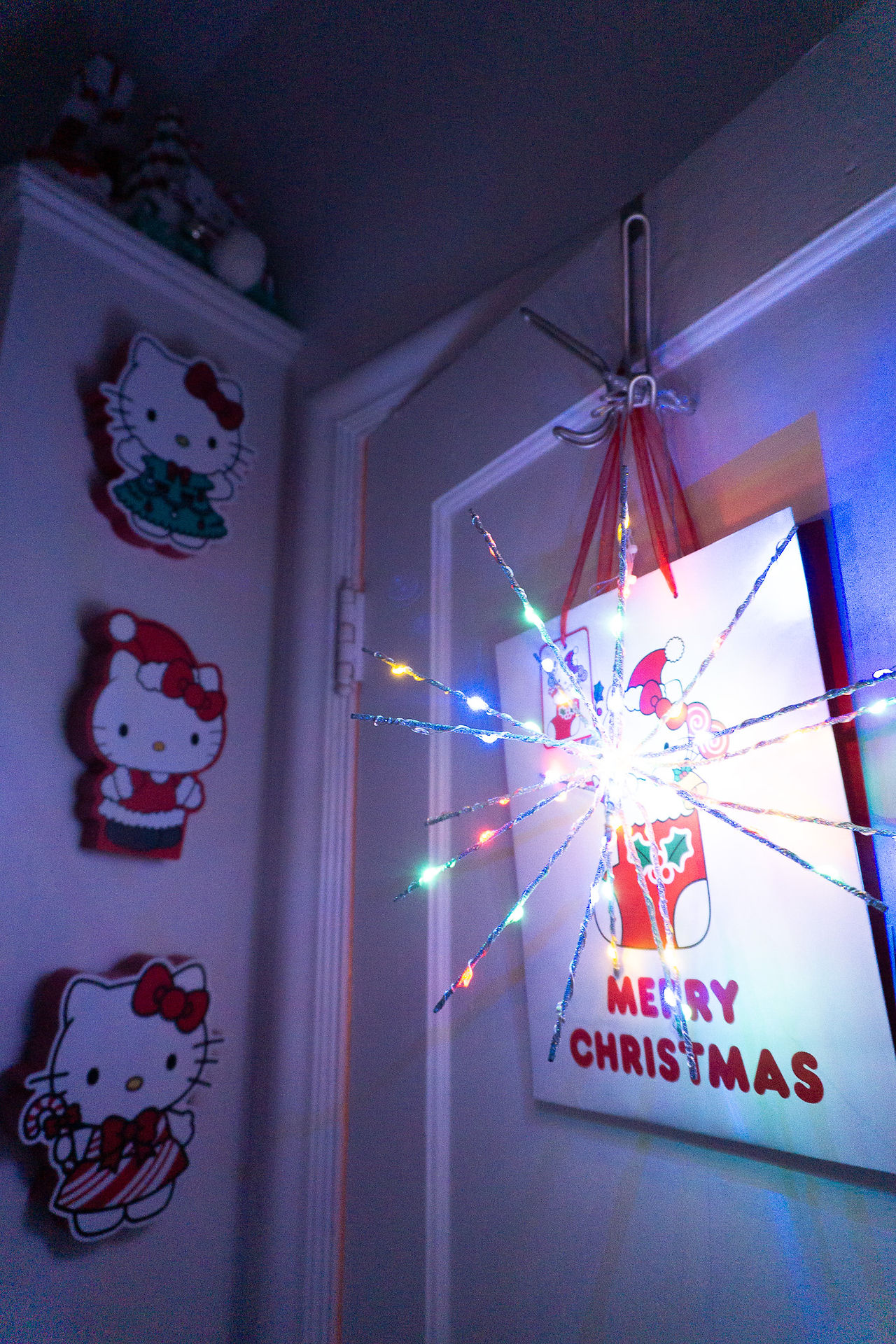 christmas hello kitty gift bag hanging behind bathroom door