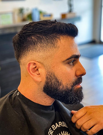 Modern men’s hairstyle by barber at Heritage Barber Co.