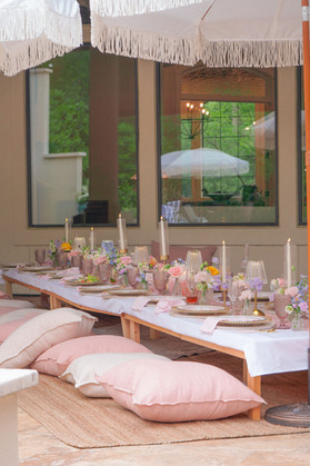 Luxury picnic bridal shower with white umbrellas, floral centerpieces, pink place settings, and romantic outdoor styling.