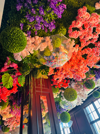 Floral ceiling installation with umbrellas creating an elevated event atmosphere at Annabelle Brasserie Houston.