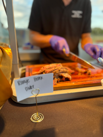 Professionally catered food display by Walker's Cafe for an outdoor milestone birthday party.