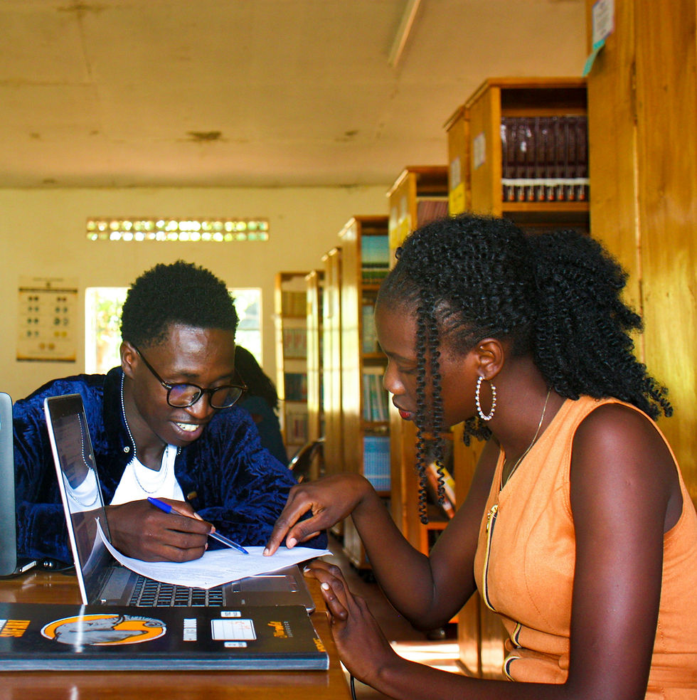 Two African students studying together in a library.