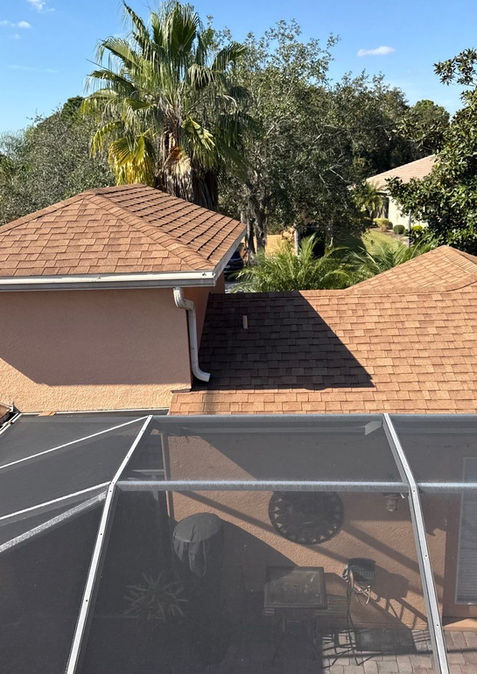 Shingle roof replacement around screened pool enclosure on a lakefront home in Poinciana FL — Gullett Roofing