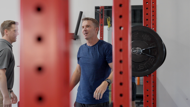 Personal Performance trainer coaching client on strength equipment — brand film by Boda Studios Charleston SC