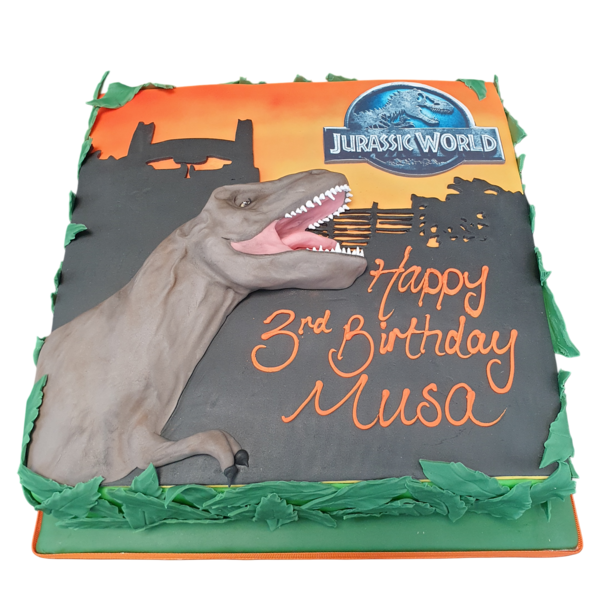 Bespoke Jurassic World celebration cake with dinosaur figures and lush greenery, crafted in Solihull, West Midlands.