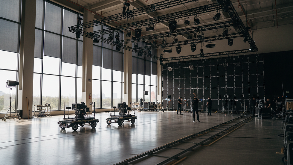 Wide angle view of a daylight stage with large windows and motorized blackout shades