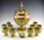 Bohemian gilded glass punchbowl set with green glass and yellow gold gilding.