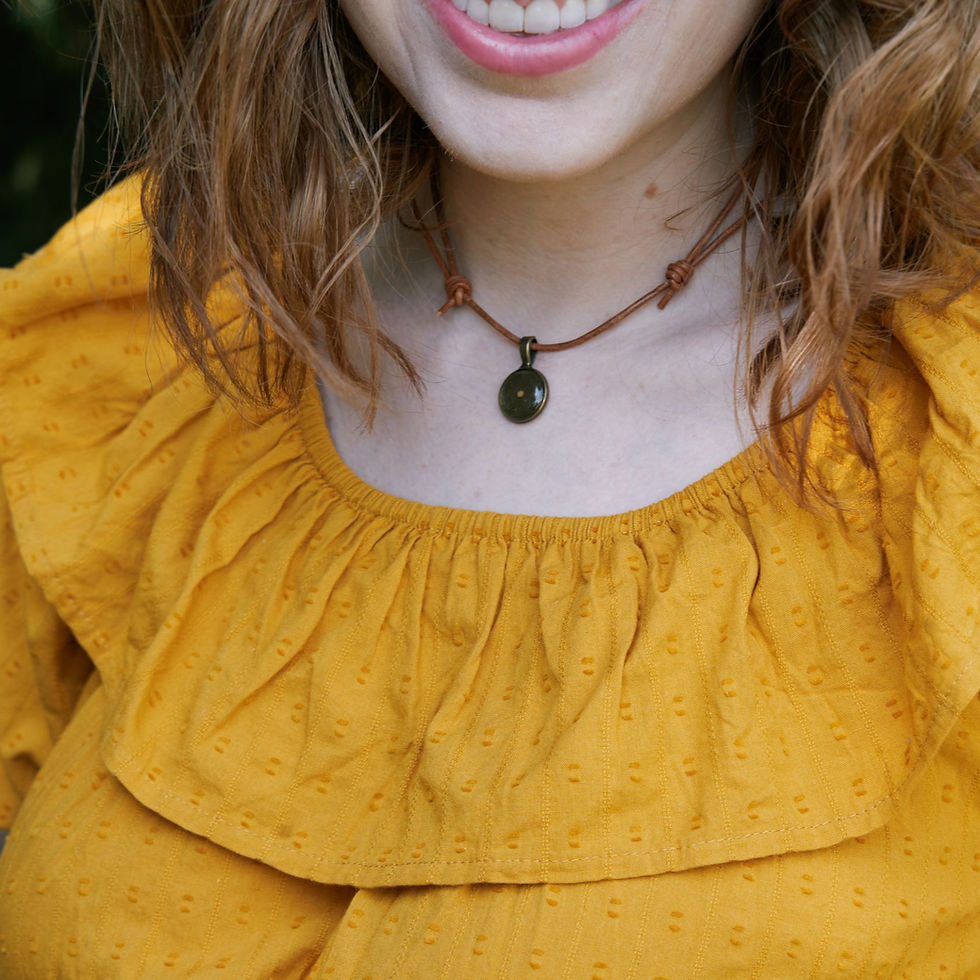 Thumbnail: Image of adult female wearing the bronze resin & rustic brown leather necklace outdoors.