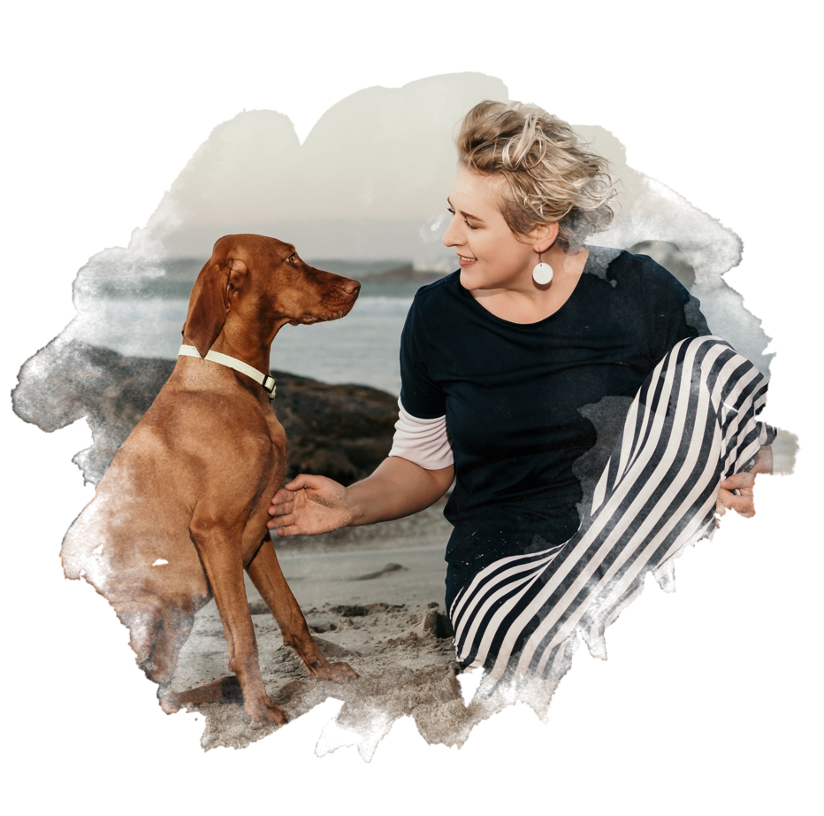 woman and her vizla on the beach interacting lovingly with watercolor effect applied