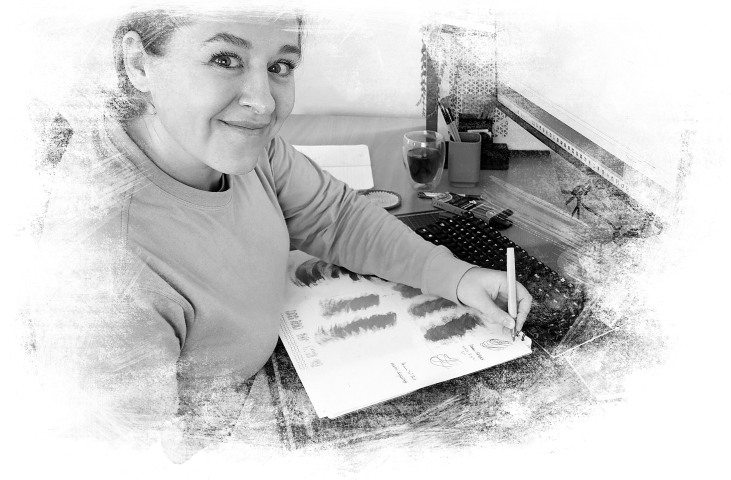creative artist working at her desk greyscale watercolor brush effect