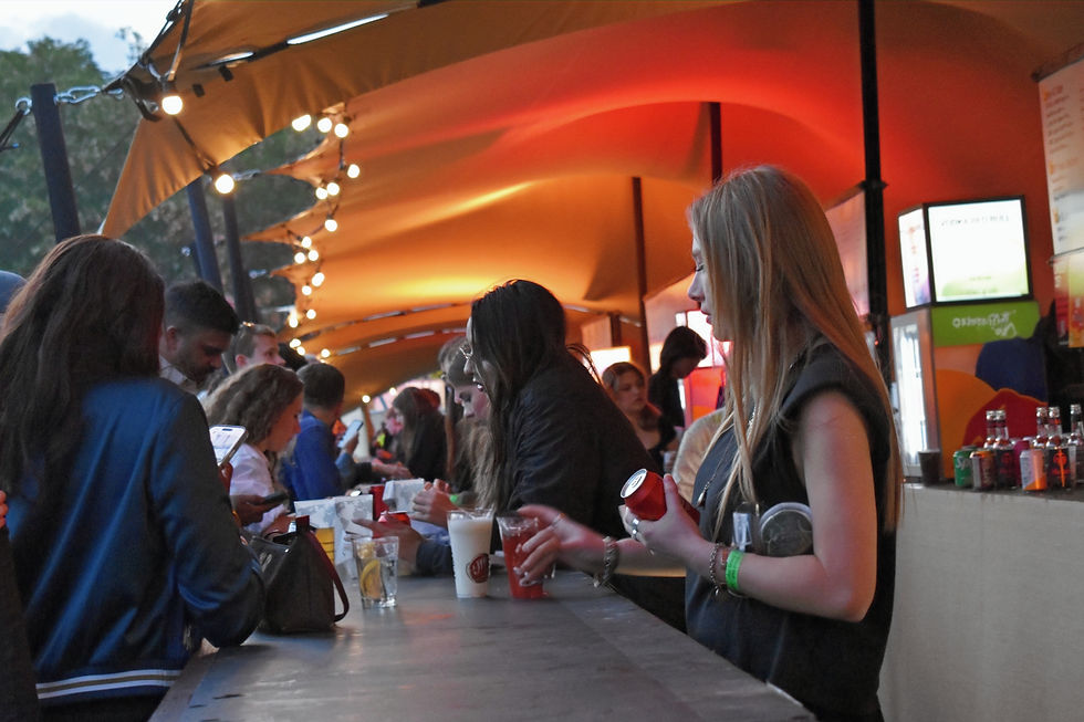People being served at a bar.