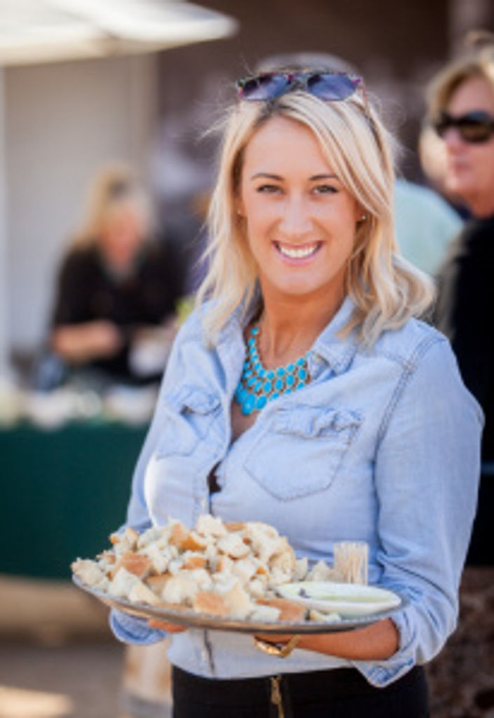 SBTHP staffer Brittany Sundberg sharing Santa Ines Mission Mills olive oil with guests. Photo by Fritz Olenberger.