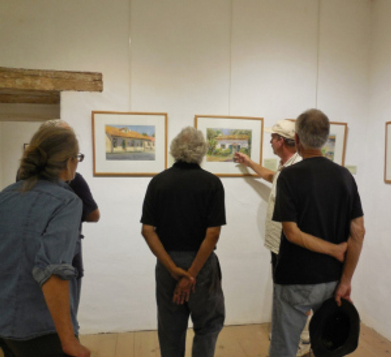Thomas Van Stein explains the use of shadow in Haass' s watercolor of the Orena Adobe. Photo by Anne Petersen.