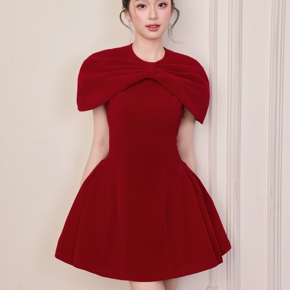 Red Roselle dress with bow cape neckline and fit-and-flare shape, elegant and feminine design.