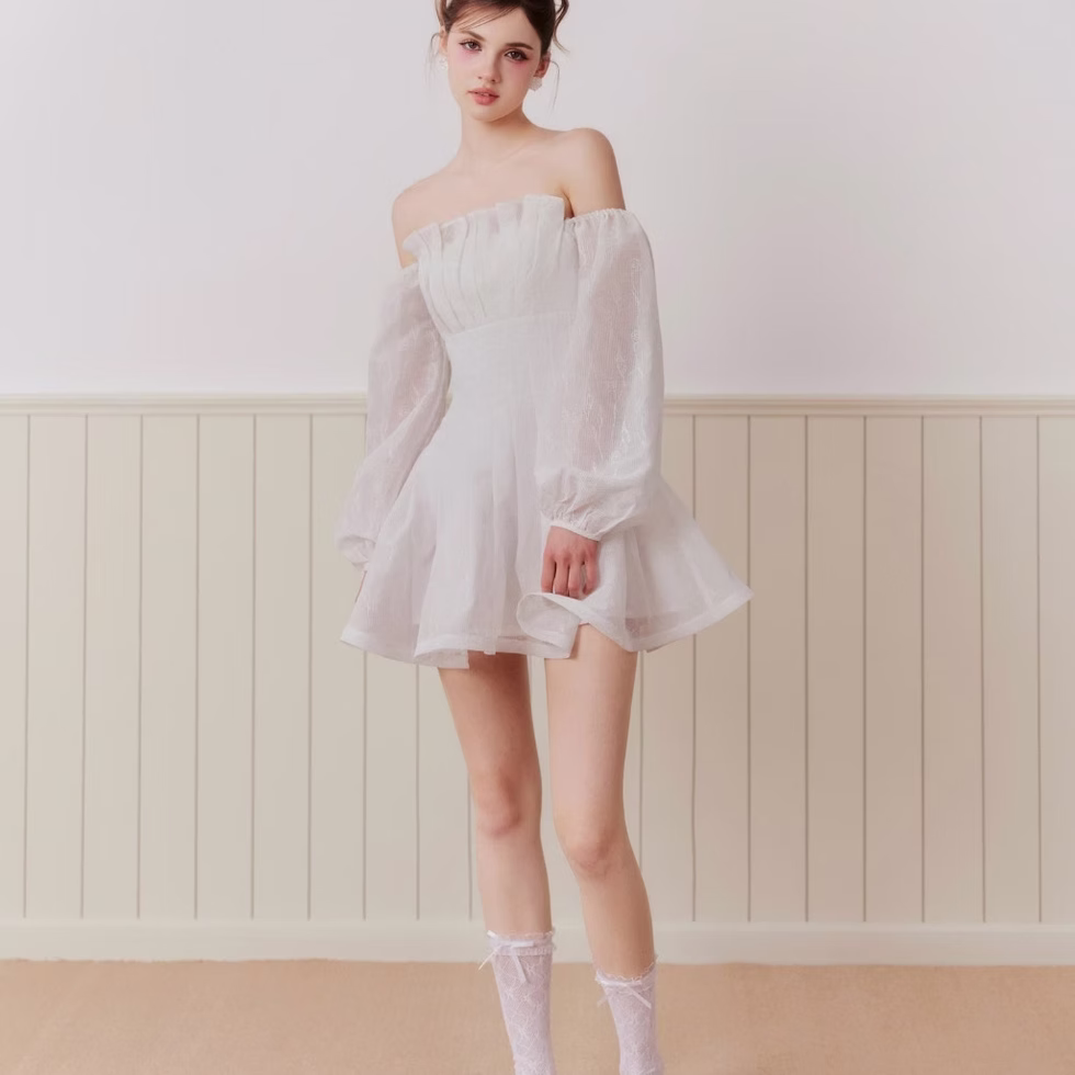 White off-shoulder flare dress with soft silhouette, flattering fit – modern romantic style by Those Studios.