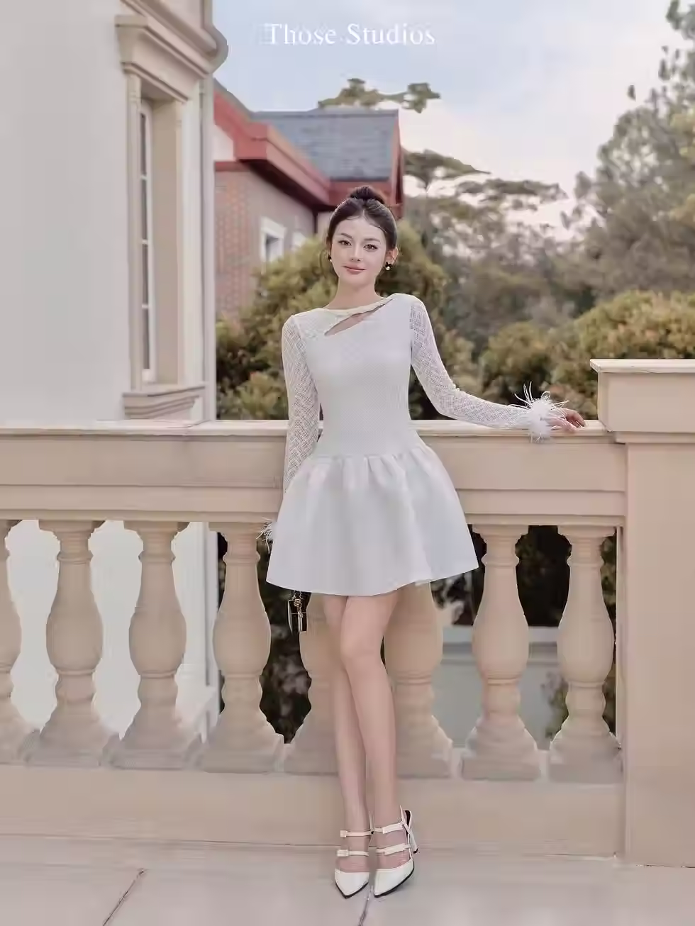 Elegant white Dandelion Dress with lace sleeves and feather cuffs, perfect for stylish evening wear and special occasions.