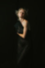 Moody boudoir photoshoot for woman in all black in photography studio near Towanda PA.