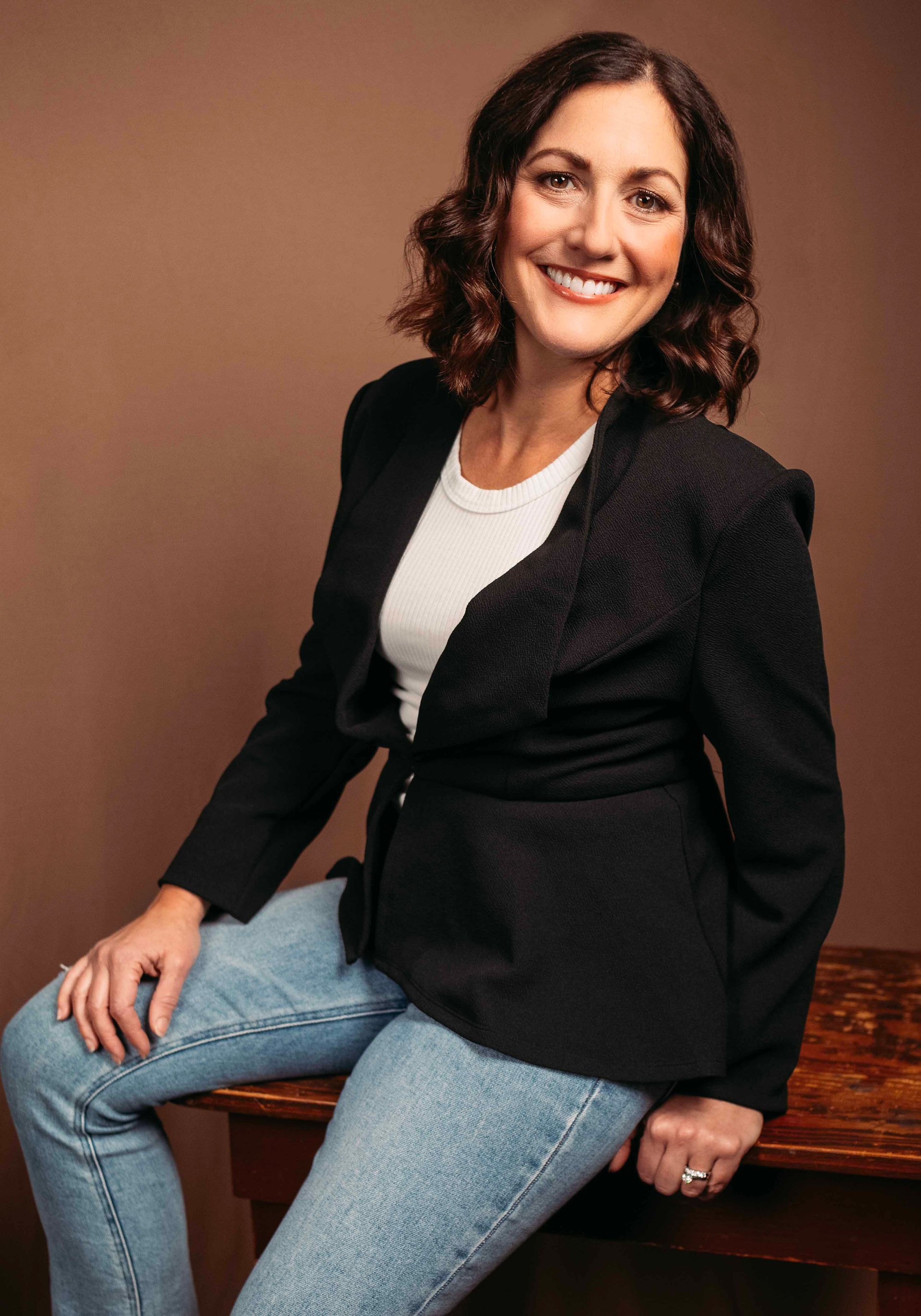 Smiling dentist on brown background during branding photoshoot in Pennsylvania