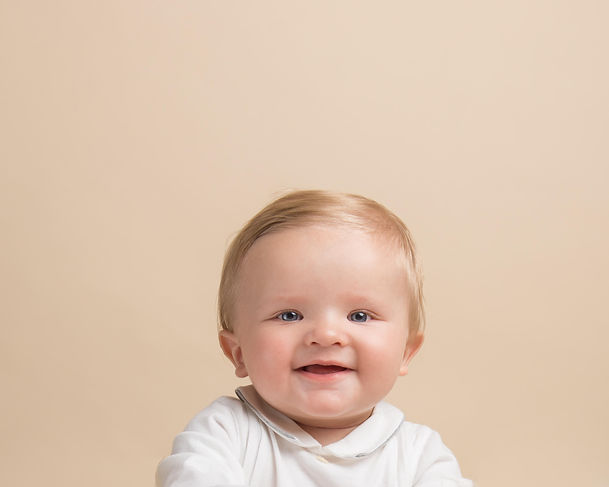portrait of a baby playing peekaboo