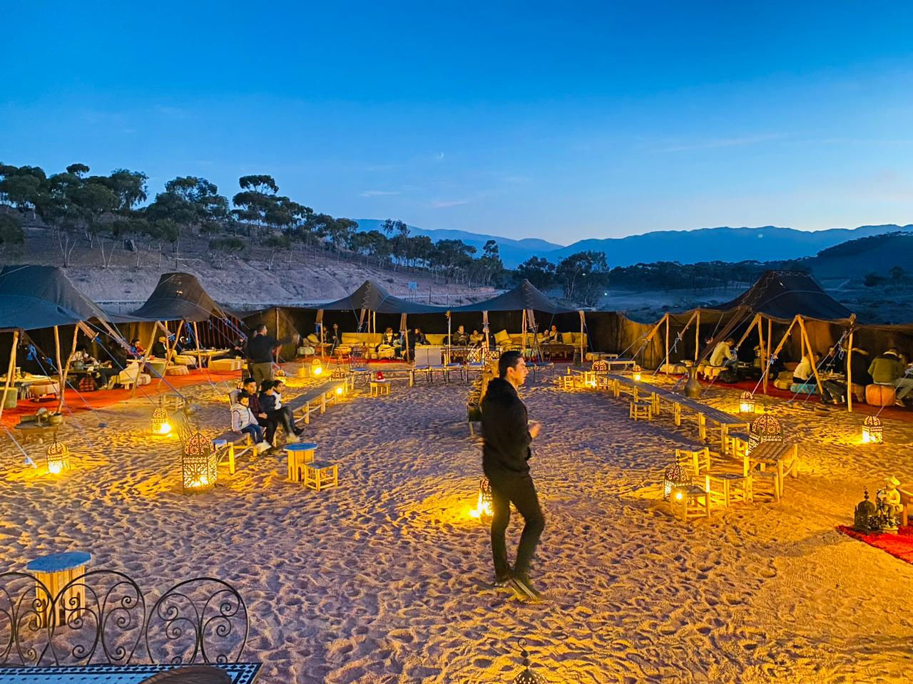 A dinner night in Agafai desert with a man in the middle of the sand