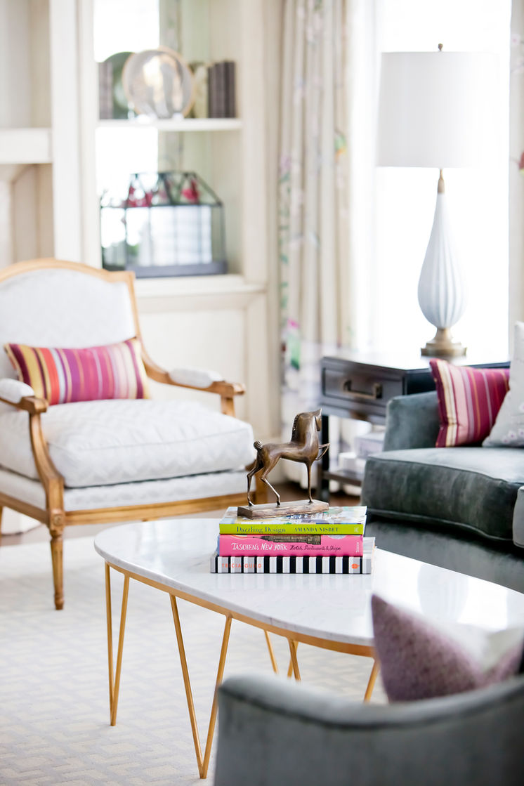 Formal living room detail with traditional armchairs, a grey sofa and white marble coffee table.