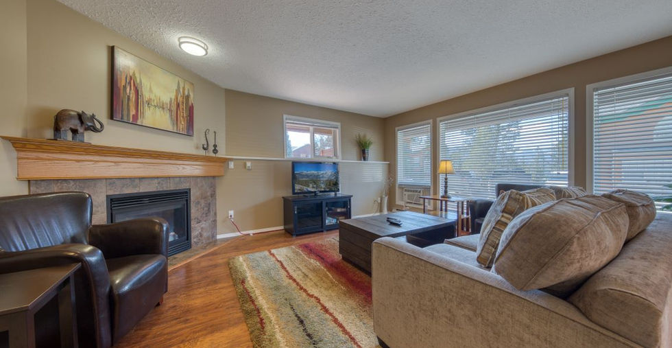 Living room area with couches, TV and fire place at Marble Canyon Phase 1 Unit 601B Fairmont