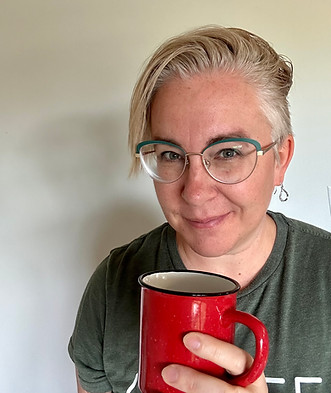 Kim Free smiling with a coffee mug