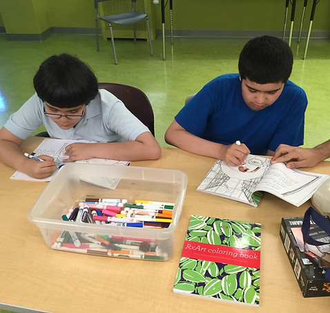 young children coloring a coloring book 