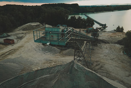 green and black metal conveyor on gray sand