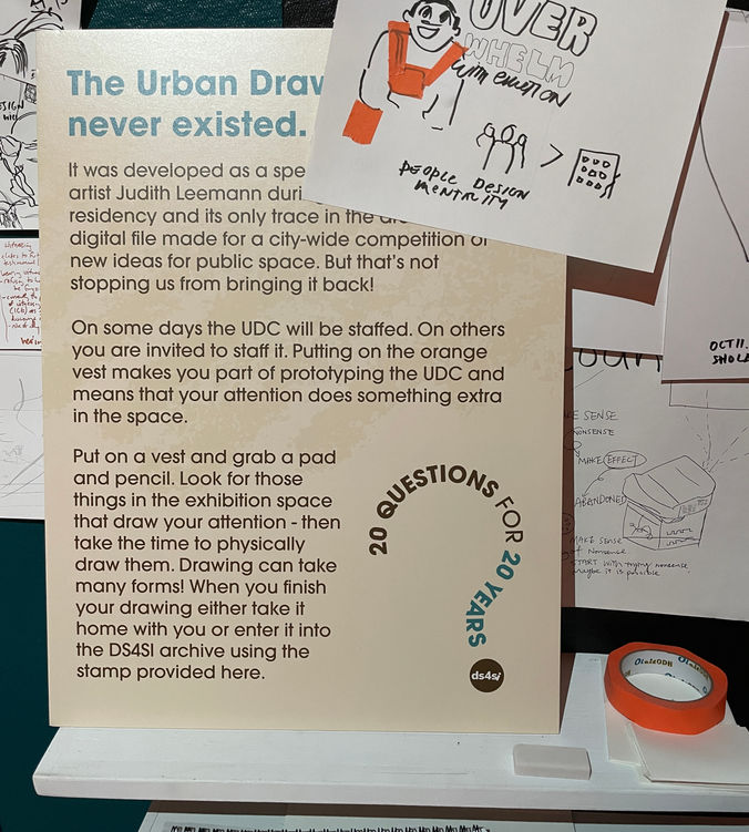 photograph of wall with a poster about the Urban Drawing Project