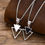 Thumbnail: Geometric Triangle Necklace.