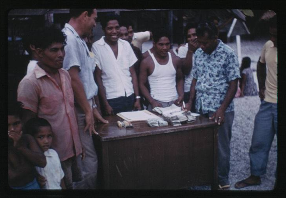 First payment from Trust Fund, 7-4-1957, Photo by Leonard Mason, Robert C. Kiste Collection, UHawaii