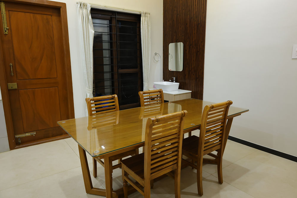Wooden dining table with four chairs and wash basin