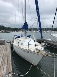 Front view of S/V Messing About in slip