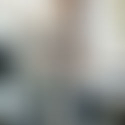 Two women happily browse through clothing items in a trendy boutique, enjoying a casual shopping experience.