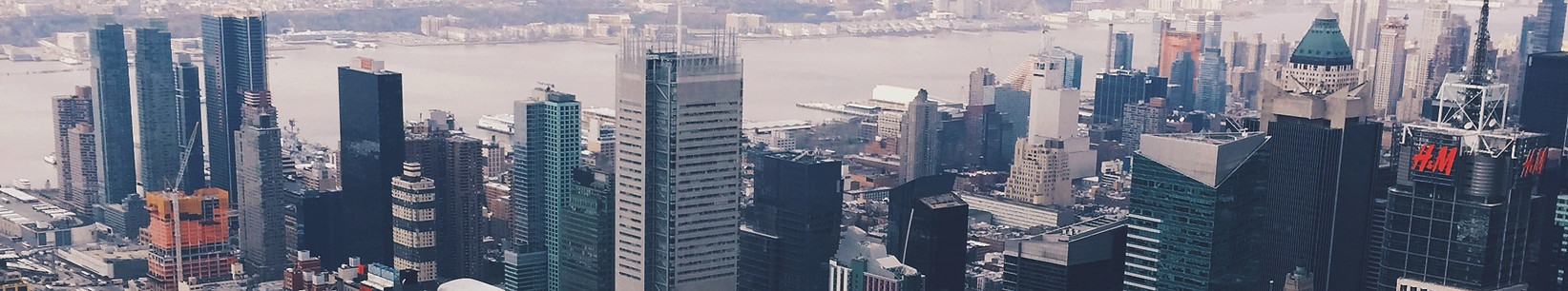 Aerial view of a densely packed urban skyline with numerous high-rise buildings and skyscrapers.