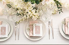 Stylish table setting with wedding invitations and gypsophila flowers, top view.jpg