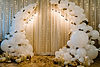 Decorated arch for wedding ceremony. White balloons, candles, autumn leaves and small pump