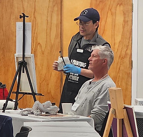 NC artist JJ Jiang offering instruction during art workshop