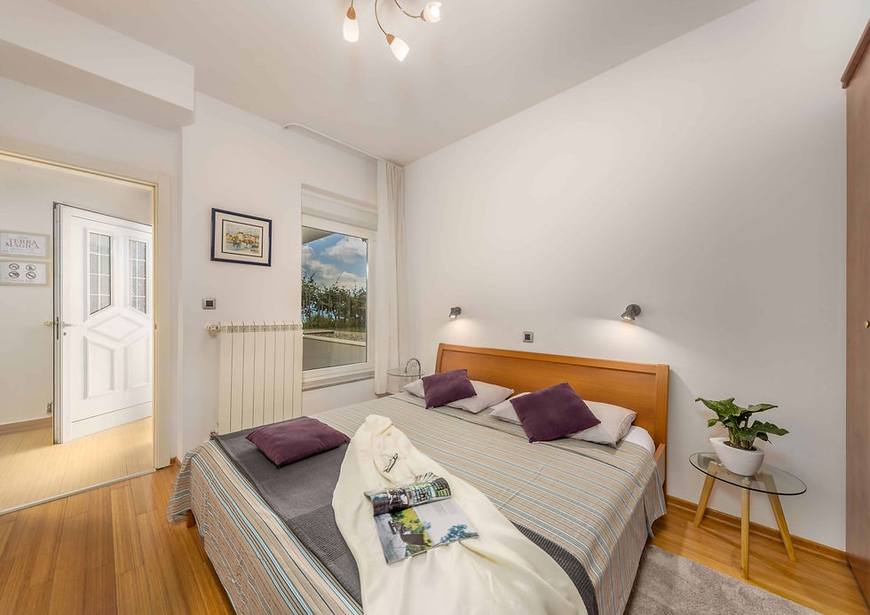 Bedroom with double bed in the Terra Magica Deluxe Apartment