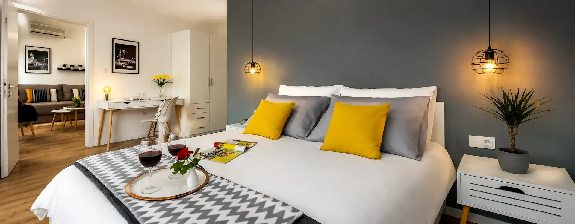 Modernt sovrum with grey accent wall and bedside table in Terra I lägenhet, Rijeka deskto