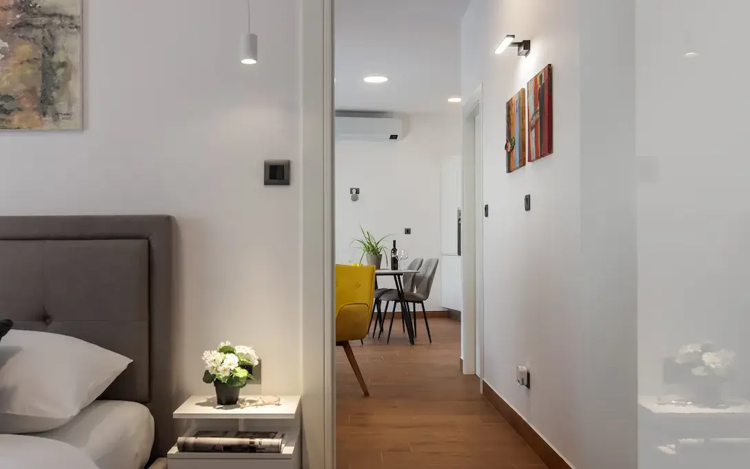 Bedroom reflected in decorative mirror in Terra 5 Deluxe apartment, Rijeka