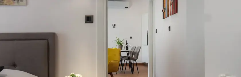 Bedroom reflected in decorative mirror in Terra 5 Deluxe apartment, Rijeka